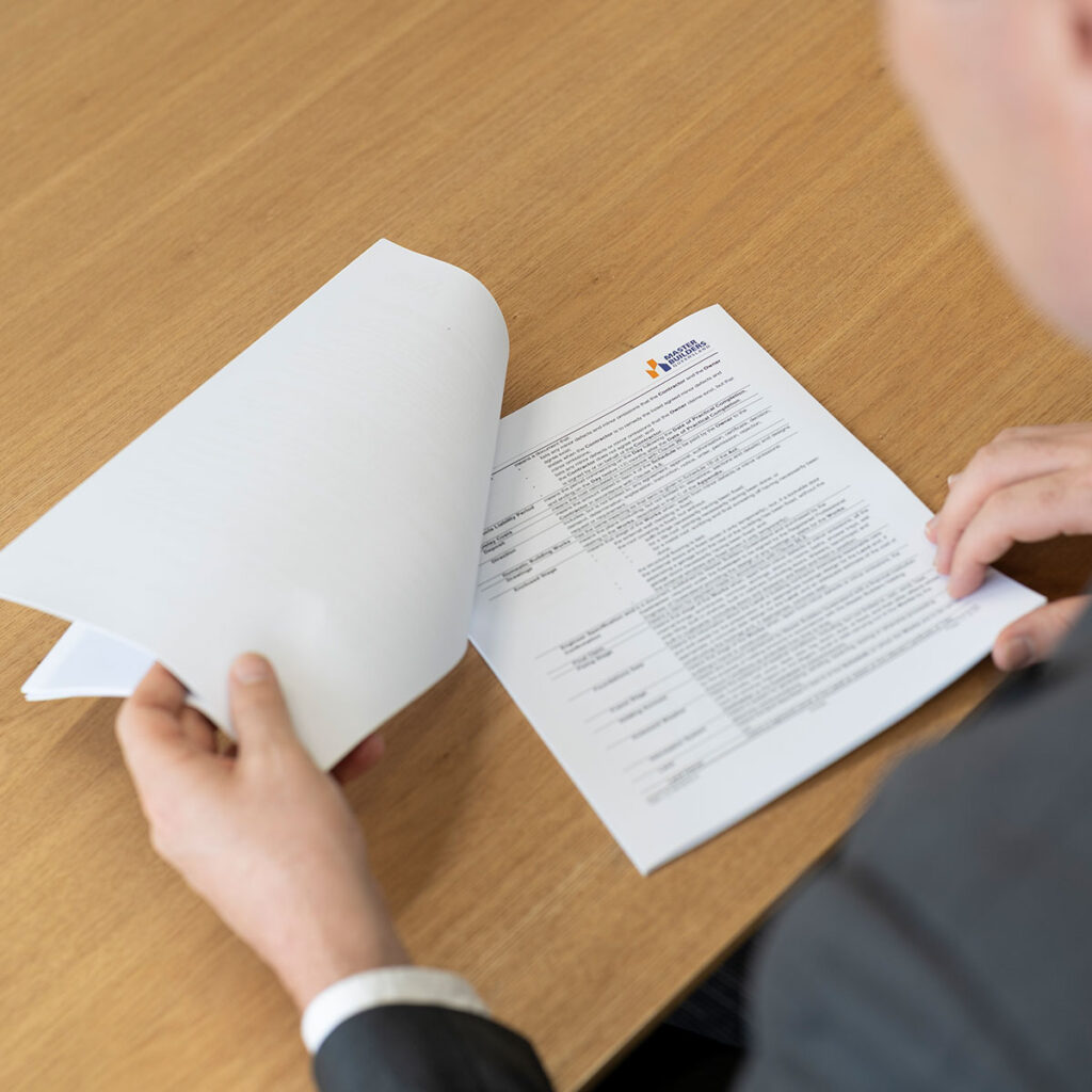 Man reading through Master Builder Queensland document